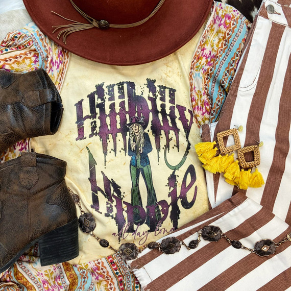 Hillbilly Hippie Screen Print Heat Transfer, vintage-inspired graphic t-shirt with a witch illustration and drippy purple text, surrounded by colorful boho accessories and footwear.