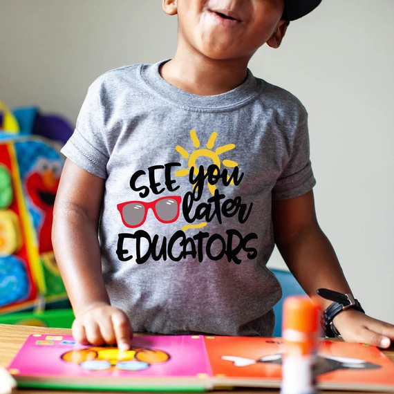 See You Later Educators DTF Heat Transfer, a colorful design featuring the phrase "See You Later Educators" with a sun and sunglasses graphic, printed on a child's gray t-shirt.