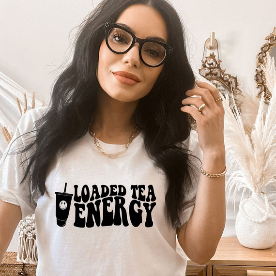 Loaded Tea Energy DTF Heat Transfer, product example on a woman's t-shirt featuring a cheerful smiley face and bold black text.