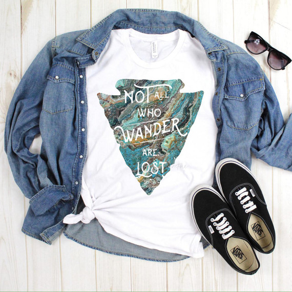 Not All Who Wander Are Lost Turquoise Arrowhead Sublimation Transfer, displayed on a white t-shirt with a marbled arrowhead design.