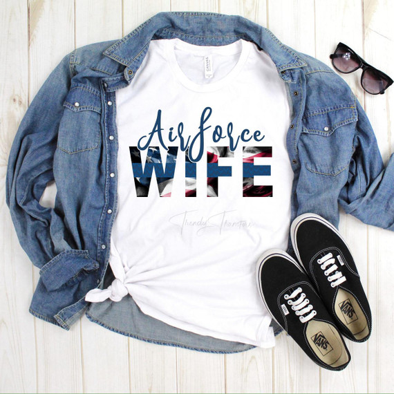Airforce Wife Blue Line Flag Sublimation Transfer T-shirt displayed with denim jacket, sunglasses, and sneakers for a patriotic fashion statement.
