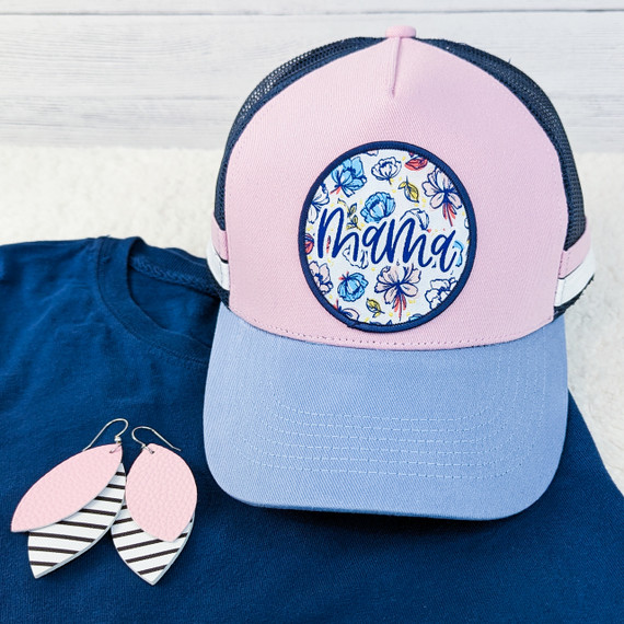 Mama Floral Embroidered Patch, pink and navy trucker cap with floral embroidery and the word Mama on the front, accompanied by pink and black striped leaf-shaped earrings.