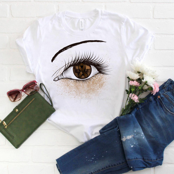 Brown Ribbon Awareness Glitter Eye Sublimation Transfer, product image of a white t-shirt with a detailed eye graphic design featuring a Brown Ribbon awareness symbol in the eye's iris.