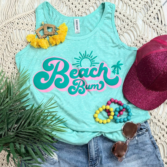 Beach Bum PUFF Screen Print Heat Transfer, turquoise sleeveless tank top with a sun and palm tree graphic, surrounded by summer accessories including a pink glitter cap, sunglasses, colorful beaded bracelets, and tropical plant, perfect for beachwear.