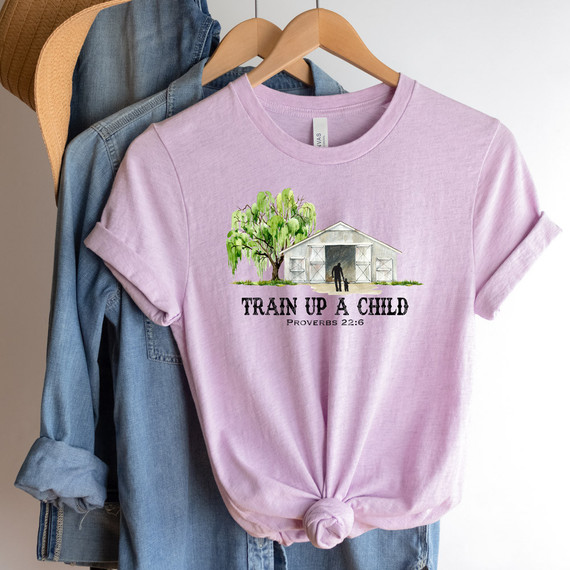 Train Up A Child DTF Heat Transfer T-shirt, pink short-sleeve shirt with biblical quote and illustration of a barn, tree, and boy and girl holding hands.