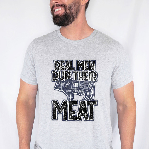 Real Men Rub Their Meat DTF Heat Transfer, humorous men's T-shirt with a graphic design of a cow cut diagram and playful text.