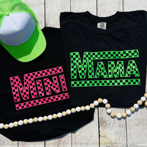 Mini Checkered NEON Pink Screen Print Heat Transfer, neon pink checkered pattern with the word 'VIVA' cut out, on a black T-shirt, and neon pink checkered pattern with the word 'VINI' cut out, on a black cloth.