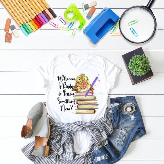 Teacher Owl Whoooo is Ready to Learn Something New Sublimation Transfer, a printed T-shirt featuring a cute owl with glasses on a stack of books, surrounded by school supplies and classroom stationery.