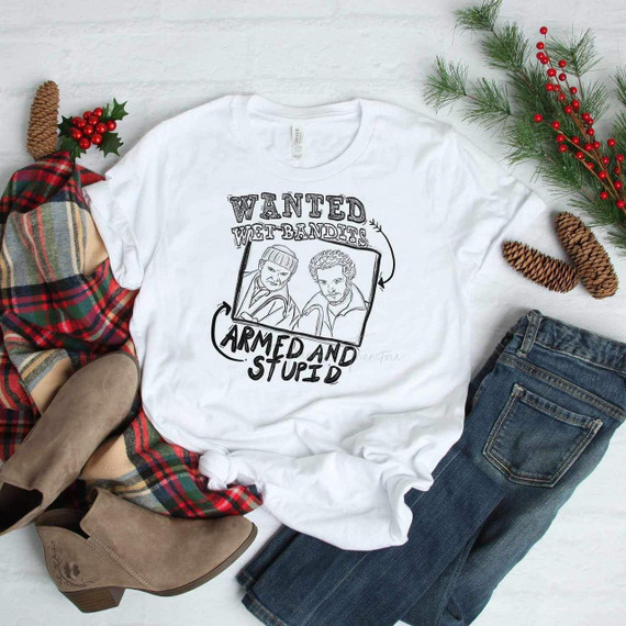 Wet Bandits Sublimation T-shirt, humorous illustrated design featuring characters with the text "Wanted Wet Bandits Armed and Stupid" on a white shirt.