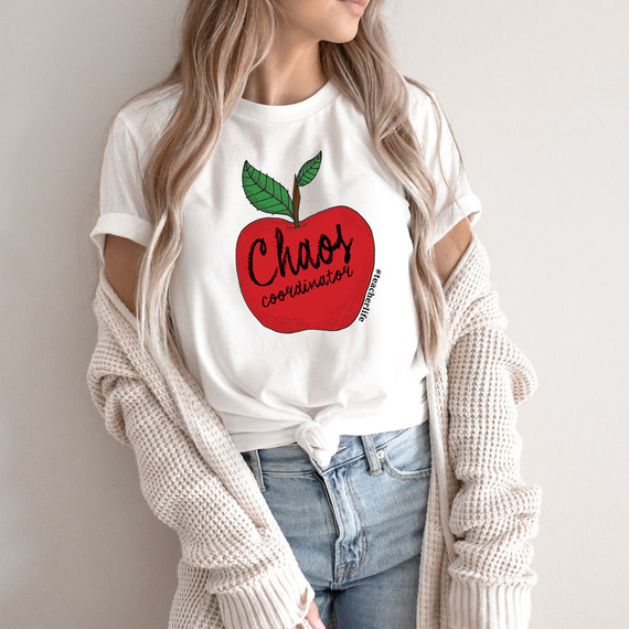 Chaos Coordinator Apple DTF Heat Transfer, a graphic design of a red apple with green leaves and the text 'Chaos Coordinator' on a white t-shirt.