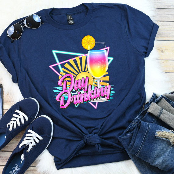 Day Drinking DTF Heat Transfer, neon-inspired colorful graphic design on a navy T-shirt with a cocktail glass and sunglasses, casual summer fashion outfit.