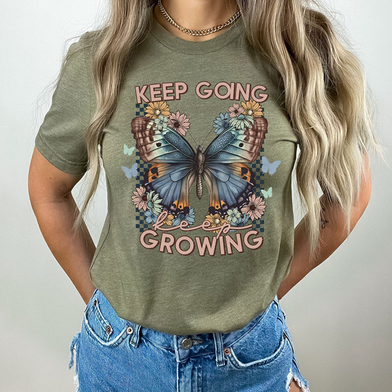 Keep Going Keep Growing DTF Heat Transfer, colorful butterfly and flower design on a green T-shirt.