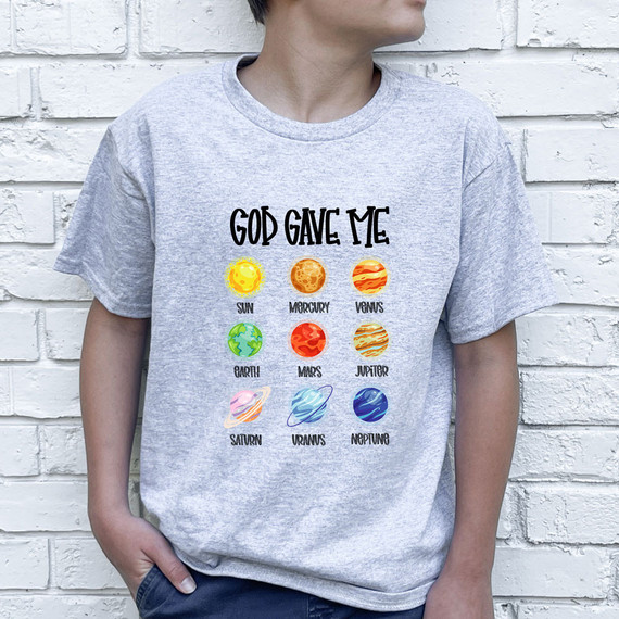 God Gave Me Space DTF Heat Transfer, colorful planetary illustrations of the sun, Mercury, Venus, Earth, Mars, Jupiter, Saturn, Uranus, and Neptune on a grey t-shirt.