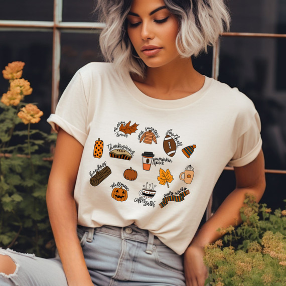 Fall Favorites DTF Heat Transfer, MITC design on a woman's t-shirt with autumn-themed icons and captions.