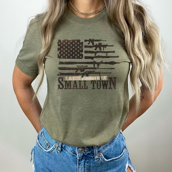 Try That In A Small Town 2nd Amendment DTF Heat Transfer, a t-shirt with a design featuring a stylized American flag made of rifles and the phrase 'Try That In A Small Town' printed on the front.