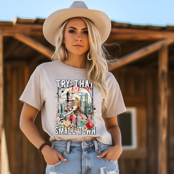 Try That In a Small Town Western DTF Heat Transfer, woman wearing a t-shirt with western desert and floral design outdoors.