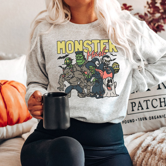 Monster Mash DTF Heat Transfer, colorful cartoon monsters and Halloween-themed design on a gray sweatshirt.