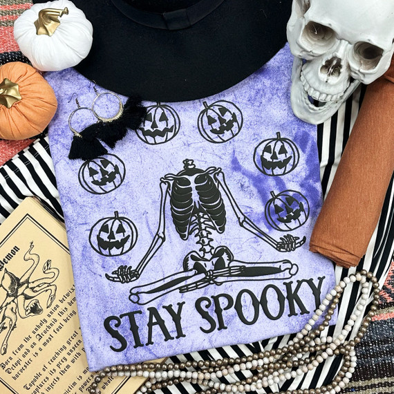 Stay Spooky Black PUFF Screen Print Heat Transfer, spooky design featuring a skeleton, pumpkins, and the text 'Stay Spooky' on purple fabric.