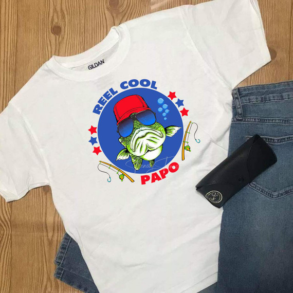 Reel Cool Papo Fishing Bass Sublimation Transfer, illustrated bass fish wearing sunglasses and a red bucket hat with fishing rods and stars, mounted on a white T-shirt.