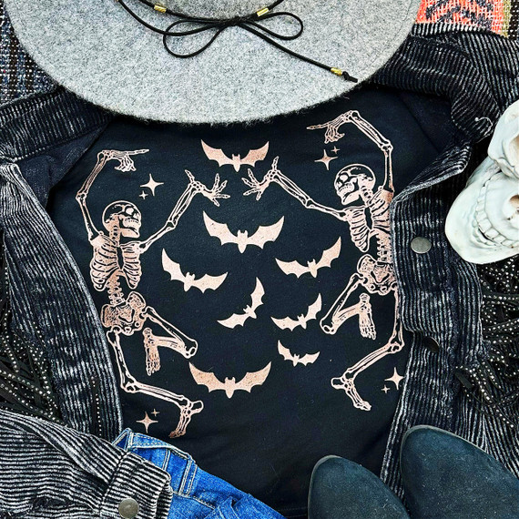 Dancing Skeletons Bats COPPER Screen Print Heat Transfer, Halloween-themed skeleton and bat design on black fabric with skulls and stars.