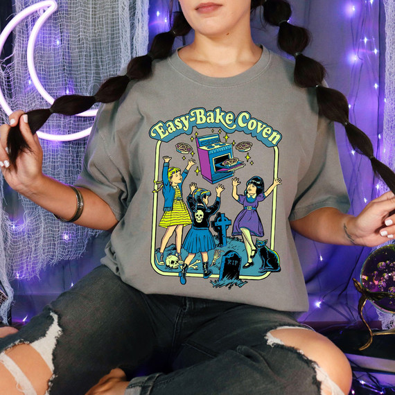 Easy Bake Coven Green DTF Heat Transfer, illustrated design of girls around an oven with spooky Halloween elements on a gray t-shirt.