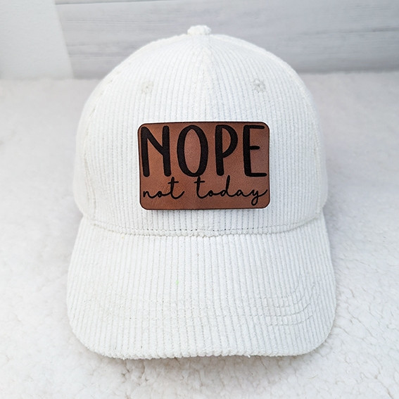 Nope Not Today Leather Hat Patch, white baseball cap with a brown leather patch featuring the text 'NOPE not today' in black and cursive font.