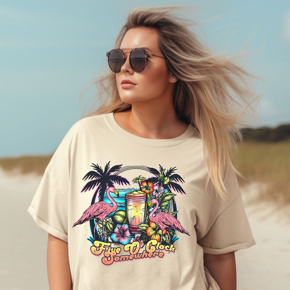 Five O'Clock Somewhere DTF Heat Transfer, colorful tropical design with flamingos, palm trees, hibiscus flowers, and a cocktail glass on a woman's t-shirt, perfect for summer casual wear.