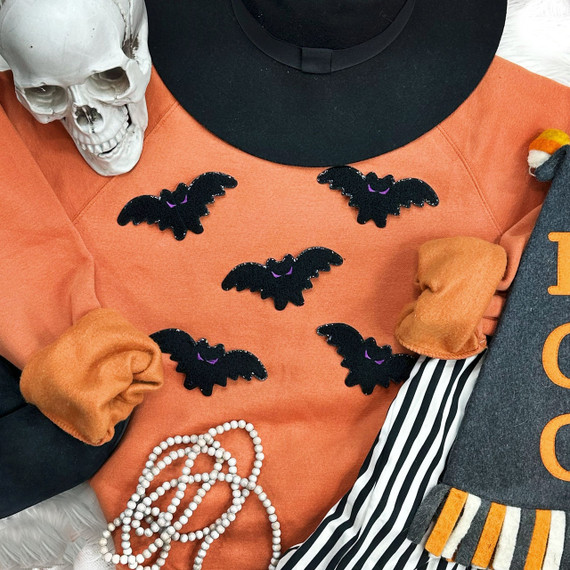 Mini Bat Chenille Patch, small black bat-shaped fabric appliqué with purple accents for Halloween decorations and crafts.