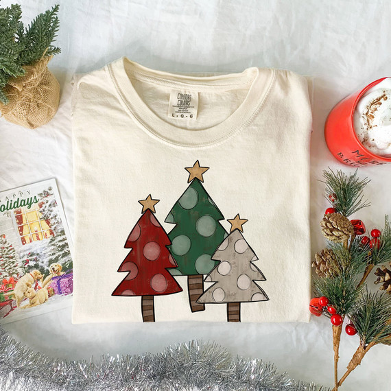 Rustic Trees DTF Heat Transfer, festive Christmas t-shirt with colorful cartoon-style Christmas trees and holiday decorations.