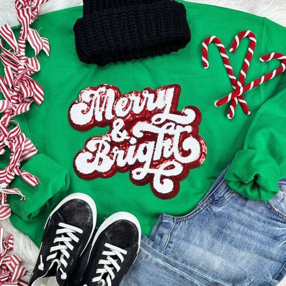 RED Merry & Bright Sequin Chenille Patch, festive holiday embroidered patch on green sweater with Christmas accessories.