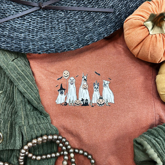 Ghost Dogs Hat/Pocket Screen Print Heat Transfer, Halloween-themed ghost dogs and pumpkins graphic on a cozy orange shirt.