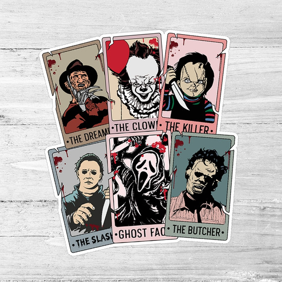 Horror Tarot Cards Die Cut Sticker, illustrated horror-themed tarot cards featuring The Dreamer, The Clown, The Killer, The Slash, Ghost Face, and The Butcher on a light wooden background.