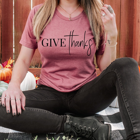 Give Thanks DTF Heat Transfer, black text on a pink t-shirt with the words 'GIVE thanks' in a modern, stylish font.