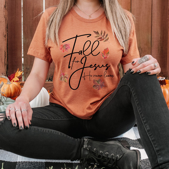 Fall For Jesus He Never Leaves DTF Heat Transfer, product showcasing a printed t-shirt with autumn leaves and Christian message.