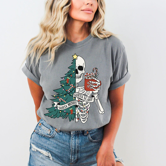 Sorta Merry Sorta Scary DTF Heat Transfer, Christmas-themed skeleton holding a candy cane and a mug, with a Christmas tree and holiday decorations on a gray t-shirt.