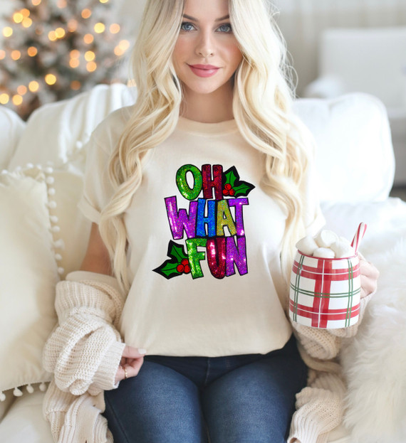 Oh What Fun Sequin Patch, colorful holiday-themed sequin patch on a woman's cream T-shirt with holly accents.