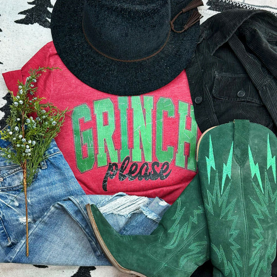 Grench Please Screen Print Heat Transfer, vibrant red t-shirt with green and black lettering, paired with green cowboy boots, black hat, black jacket, and denim jeans on a patterned background.