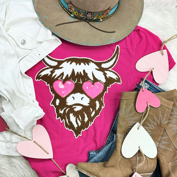 Shaggy Cow Chenille Patch, a colorful animal patch featuring a cow with heart-shaped eyes on a pink t-shirt.