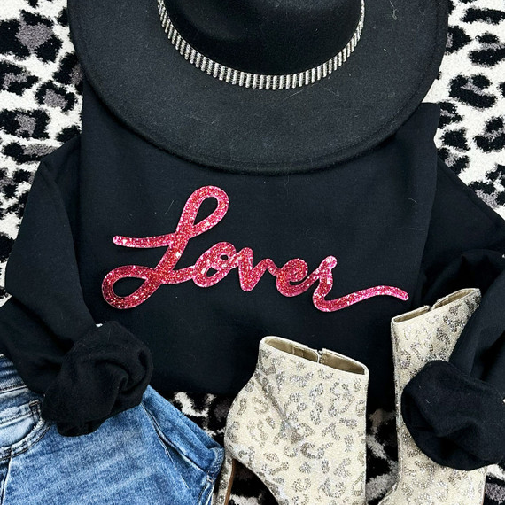 LOVER Red Sequin Patch, pink glittery word 'Lover' on black sweater with black hat, denim jeans, and leopard print boots on black and white patterned background.