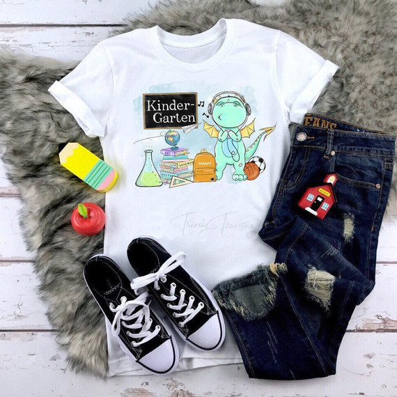 Back To School Dragon Blue Kindergarten Sublimation Transfer, children's white t-shirt with a cartoon dragon and school-related graphics.