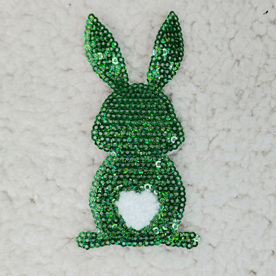Green Sequin Bunny Pocket Sized Patch, decorative patch with shiny green sequins in the shape of a bunny with a heart-shaped cutout on its belly, designed for clothing or accessories embellishment.