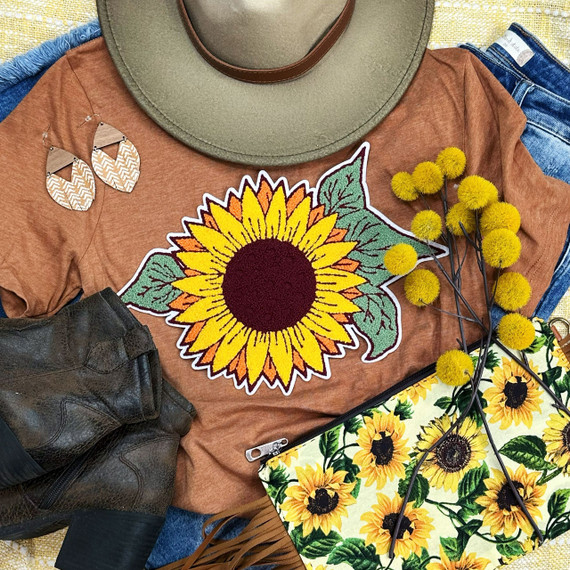 Sunflower Chenille Patch, colorful embroidered sunflower patch with green leaves on brown t-shirt.