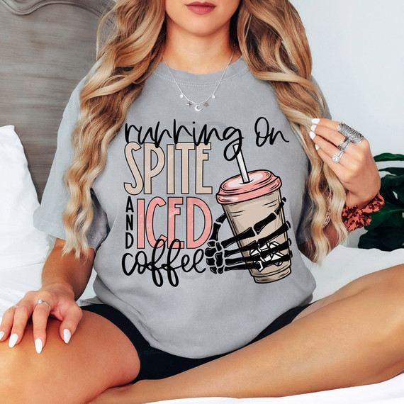 Running On Spite And Iced Coffee DTF Heat Transfer, a graphic T-shirt with text and a skeleton hand holding a iced coffee cup.