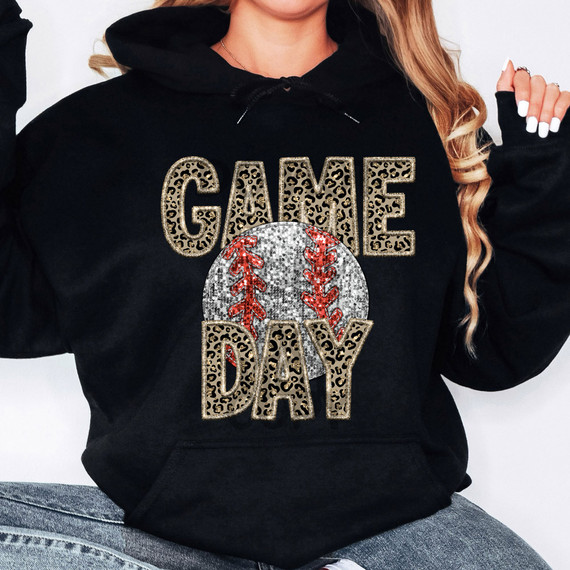 Leopard Baseball Game Day Faux Sequins DTF Heat Transfer, close-up of a woman wearing a black hoodie with a sequined baseball and Leopard print letters spelling 'GAME DAY'.