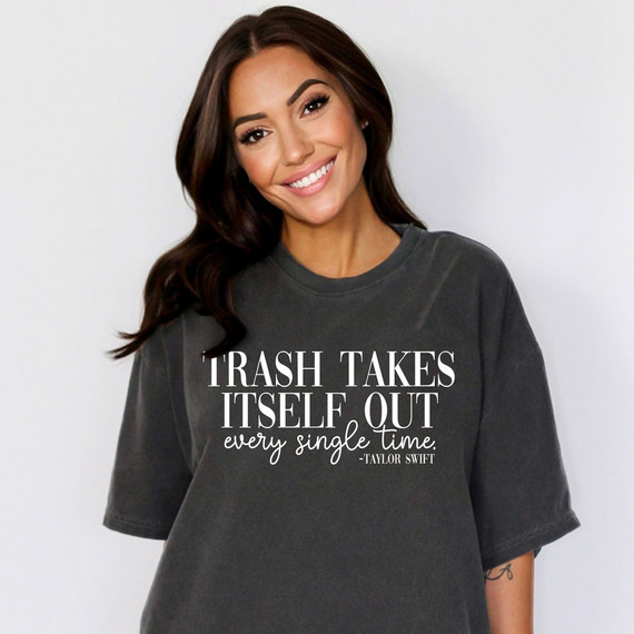 White DTF Heat Transfer, Trash Takes Itself Out every single time quote on a woman's dark t-shirt.