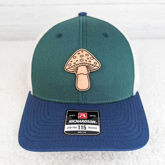 Big Mushroom Leather Hat Patch, green and blue Richardson trucker cap with mushroom embroidered patch on the front.