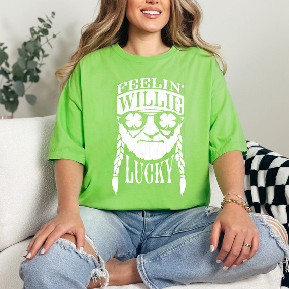 Feelin' Willie Lucky DTF Heat Transfer, Bright green T-shirt with white graphic design of a smiling man with braided hair and sunglasses, featuring text "Feelin' Willie Lucky."