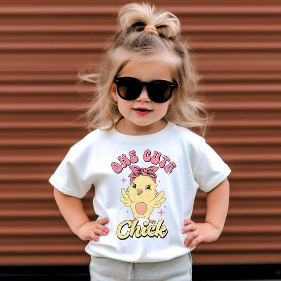 One Cute Chick DTF Heat Transfer, adorable young girl wearing a white T-shirt with a cartoon chick and pink bow design.