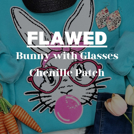 FLAWED Bunny with Glasses Chenille Patch, a cute bunny patch with glasses sewn onto a blue fabric with other accessories around.