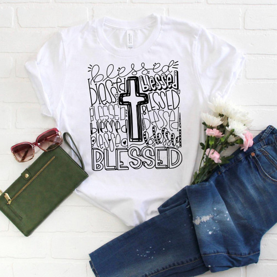 Blessed typography Sublimation Transfer, a white T-shirt with a black cross design and the word Blessed repeatedly written in various styles.